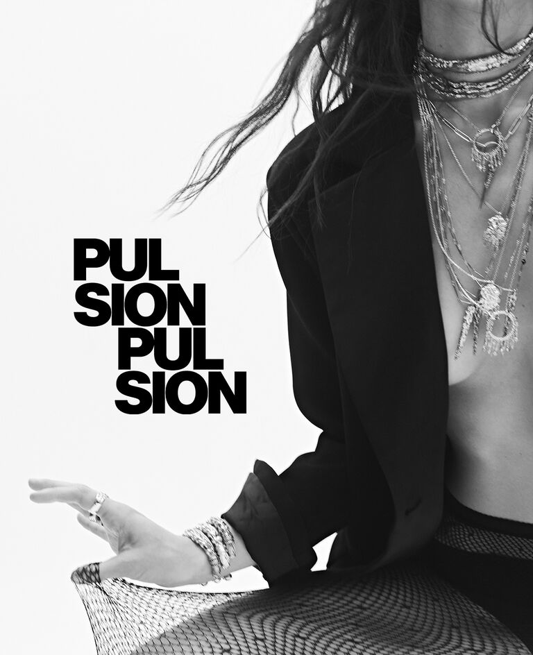 A model wearing ba&sh jewelry and a blazer, the photo is in black and white. 