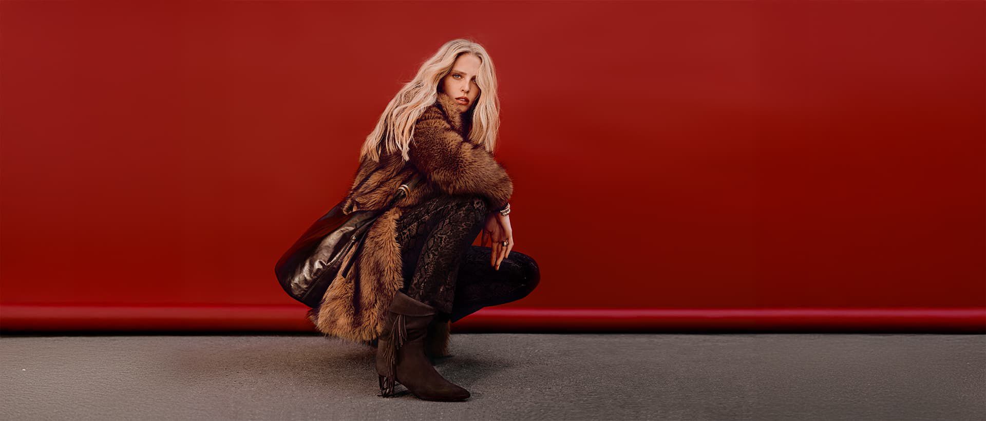 Abby Champion wearing a fur coat & a Youyou bag