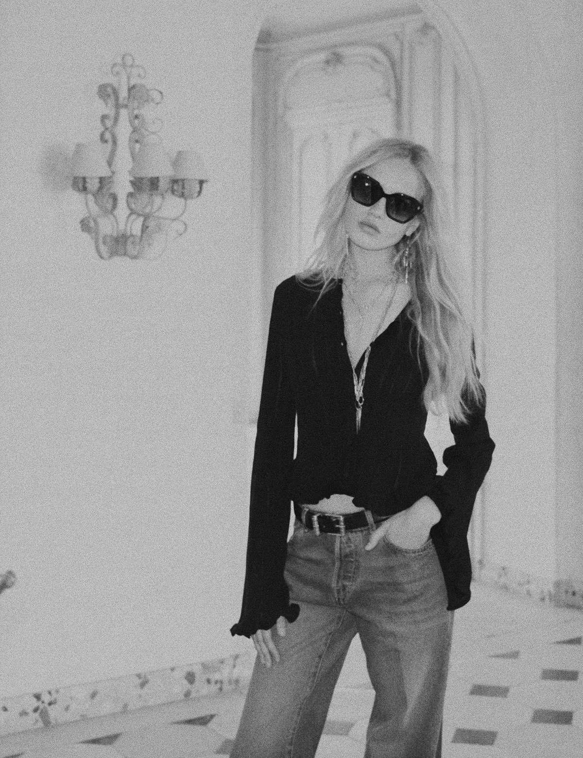 ba&sh friday, woman wearing a black top and sunglasses, the photo is in black and white. 