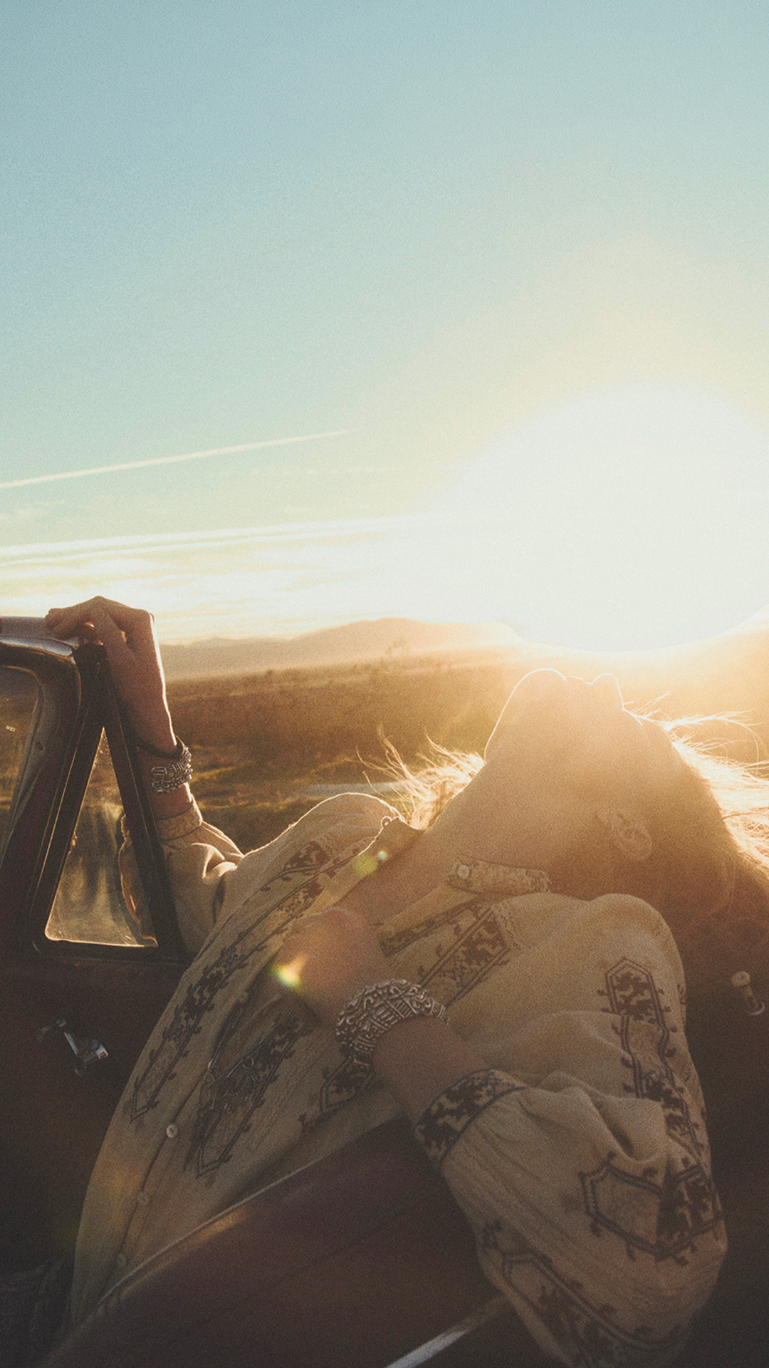 A model inside a car with sun