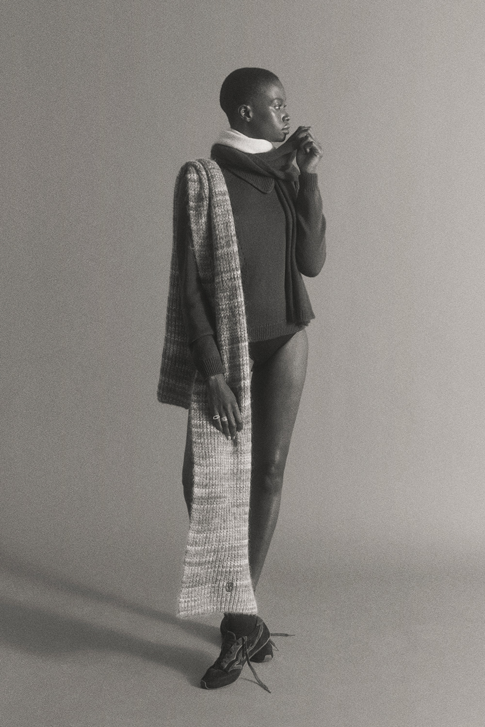 woman wearing a long knitted scarf in multicolour