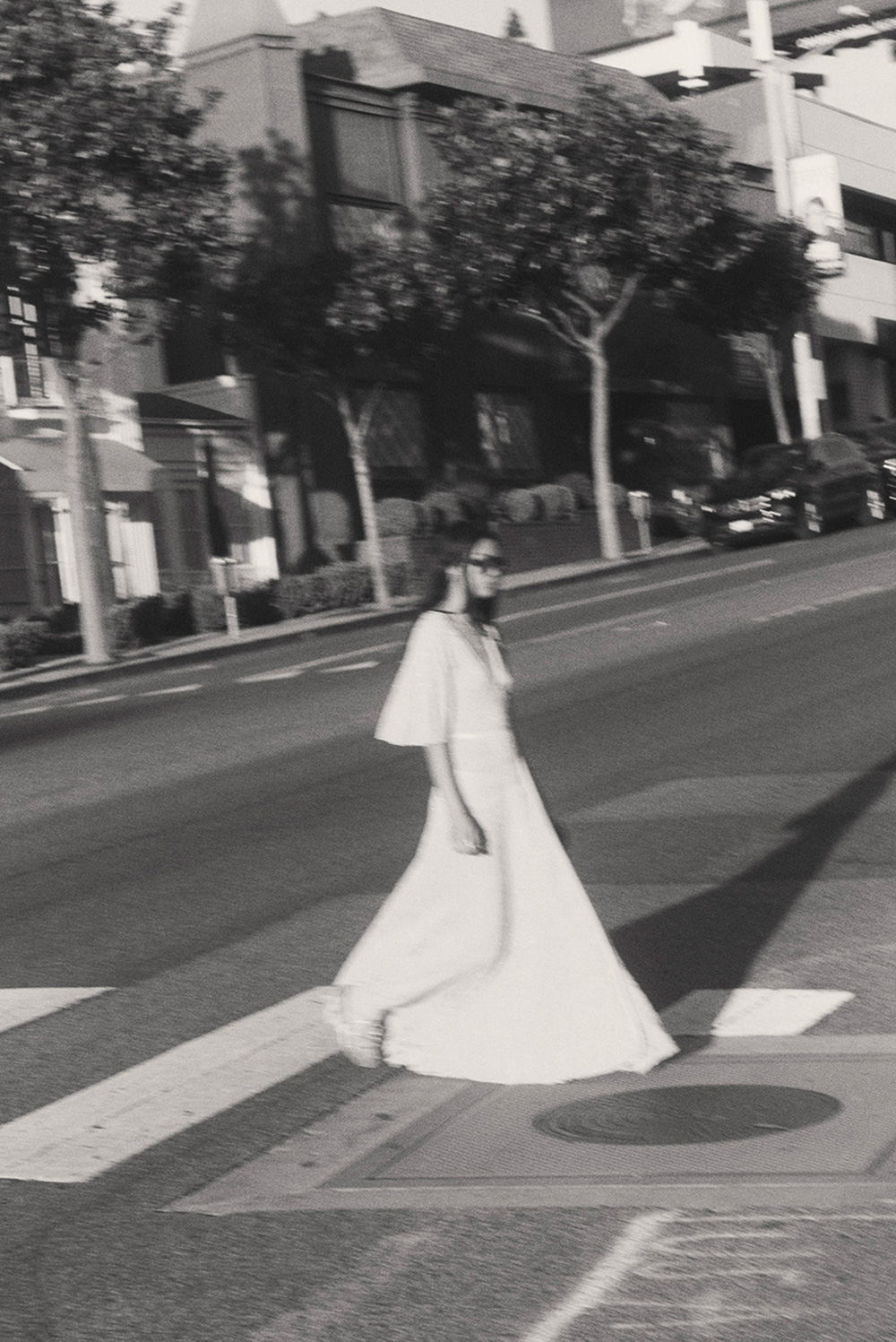 A model walking down the street in a long dress