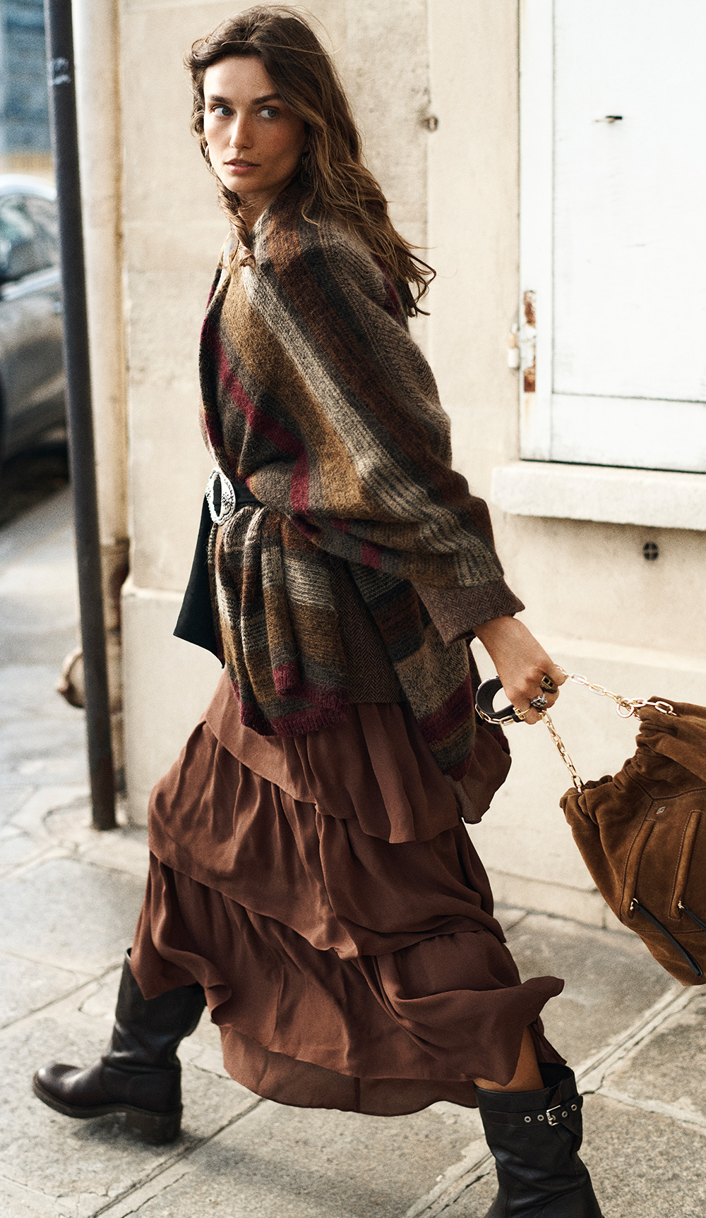 The model is wearing a poncho