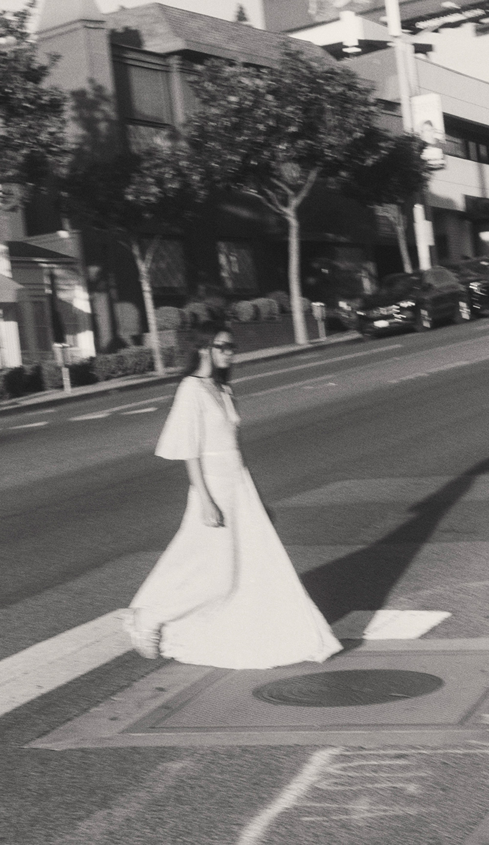A model walking down the street in a long dress