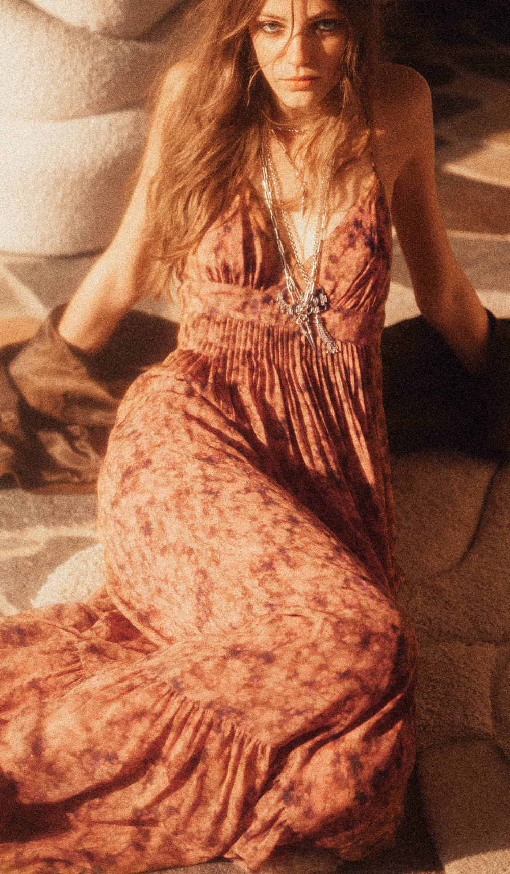 a model wearing a long, printed pink dress