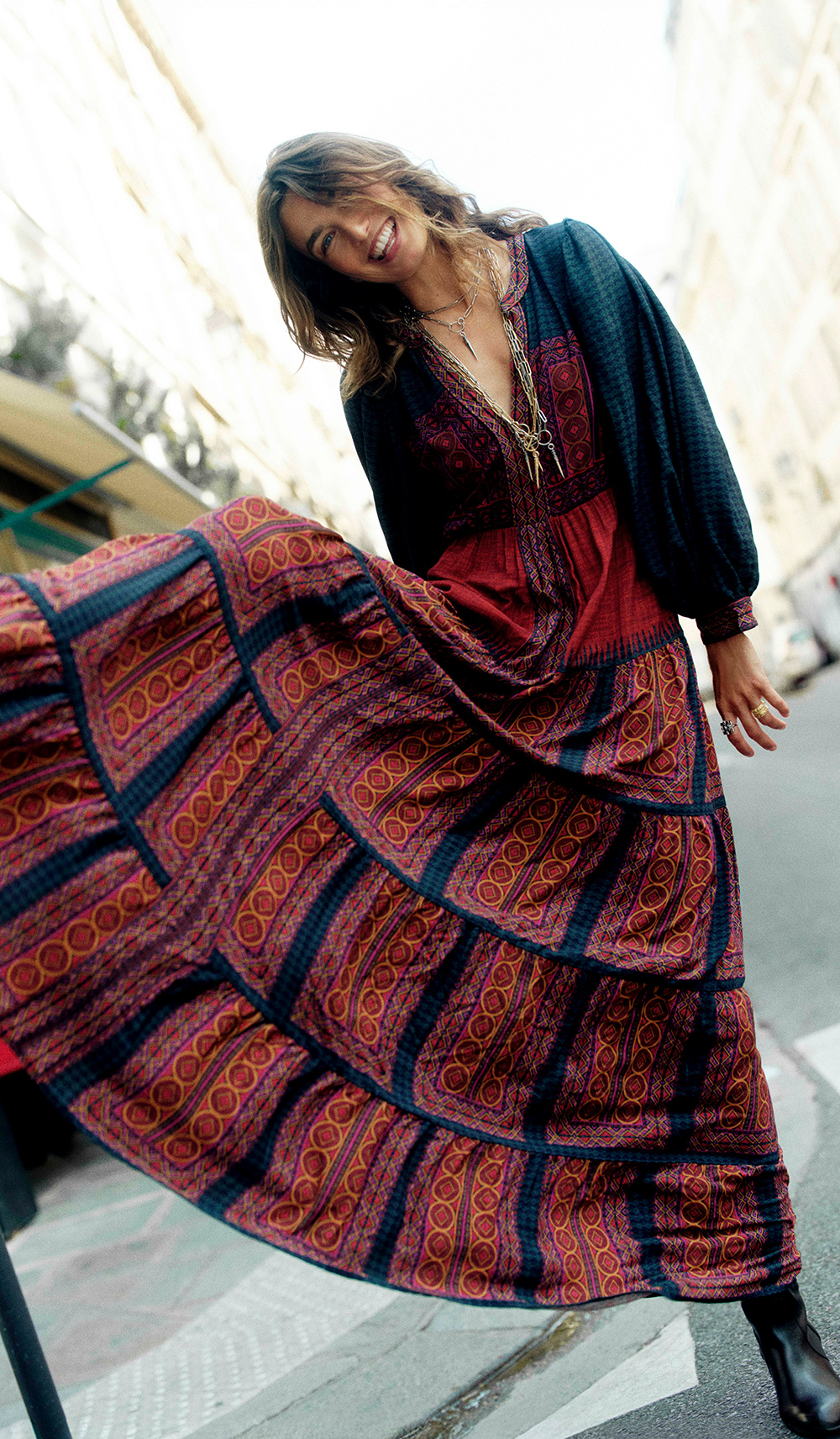 Andreea wearing a fur coat and a colorful dress