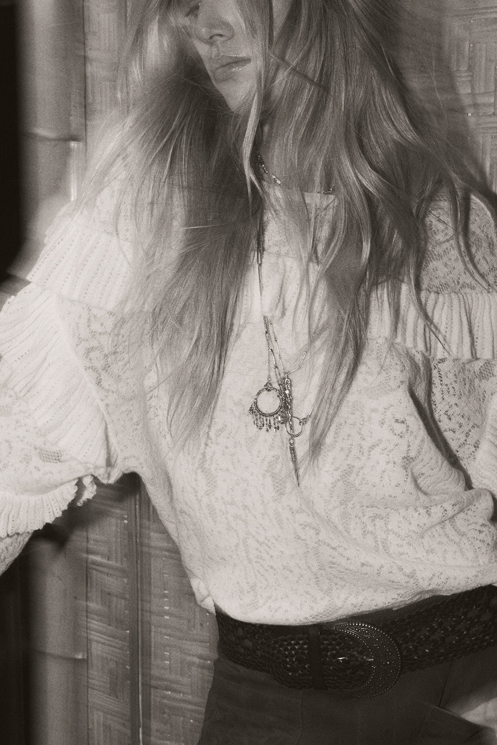 A blonde model wearing a white shirt with a ba&sh necklace