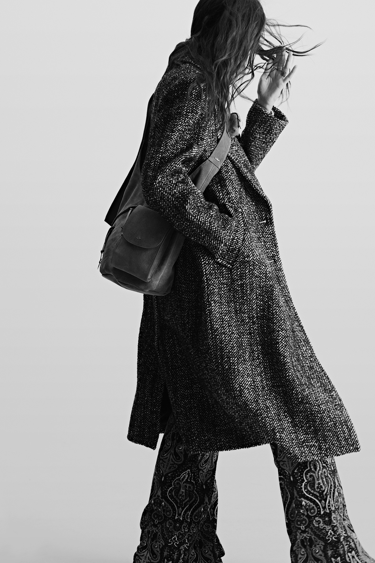 A model wearing a long grey coat and the Youyou bag