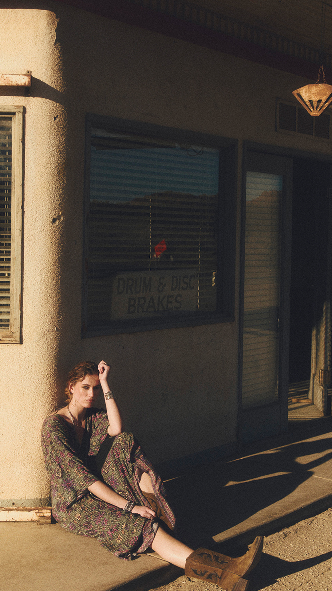A model wearing a floral-print dress and boots