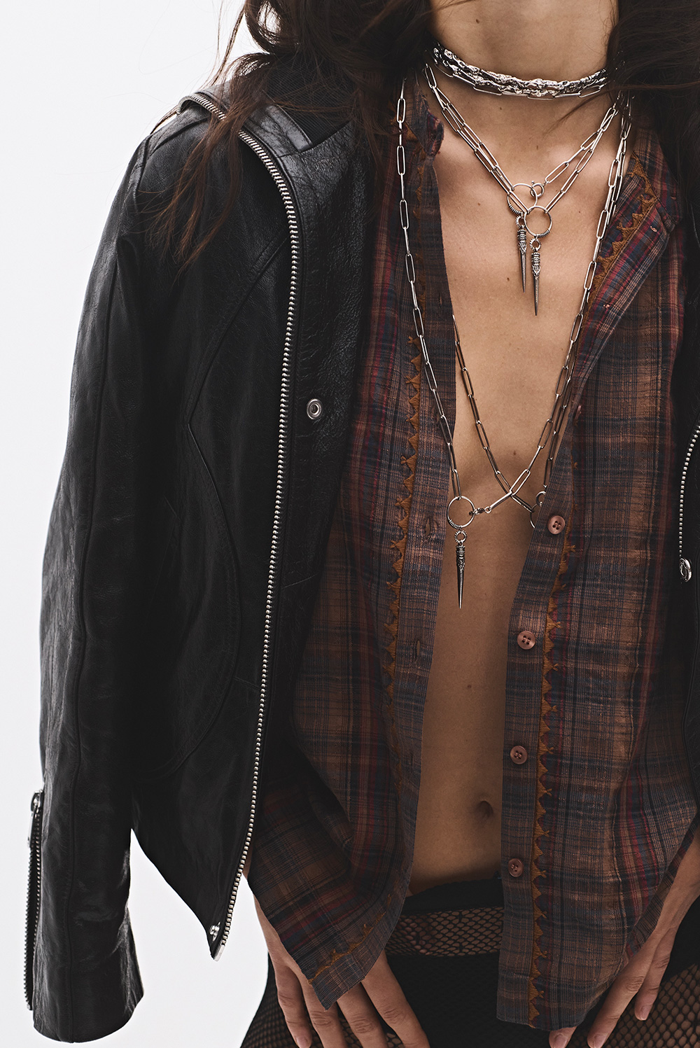 a model wearing ba&sh jewelry and a brown leather jacket