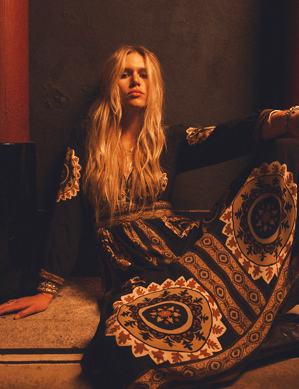 A model wearing a long black printed dress