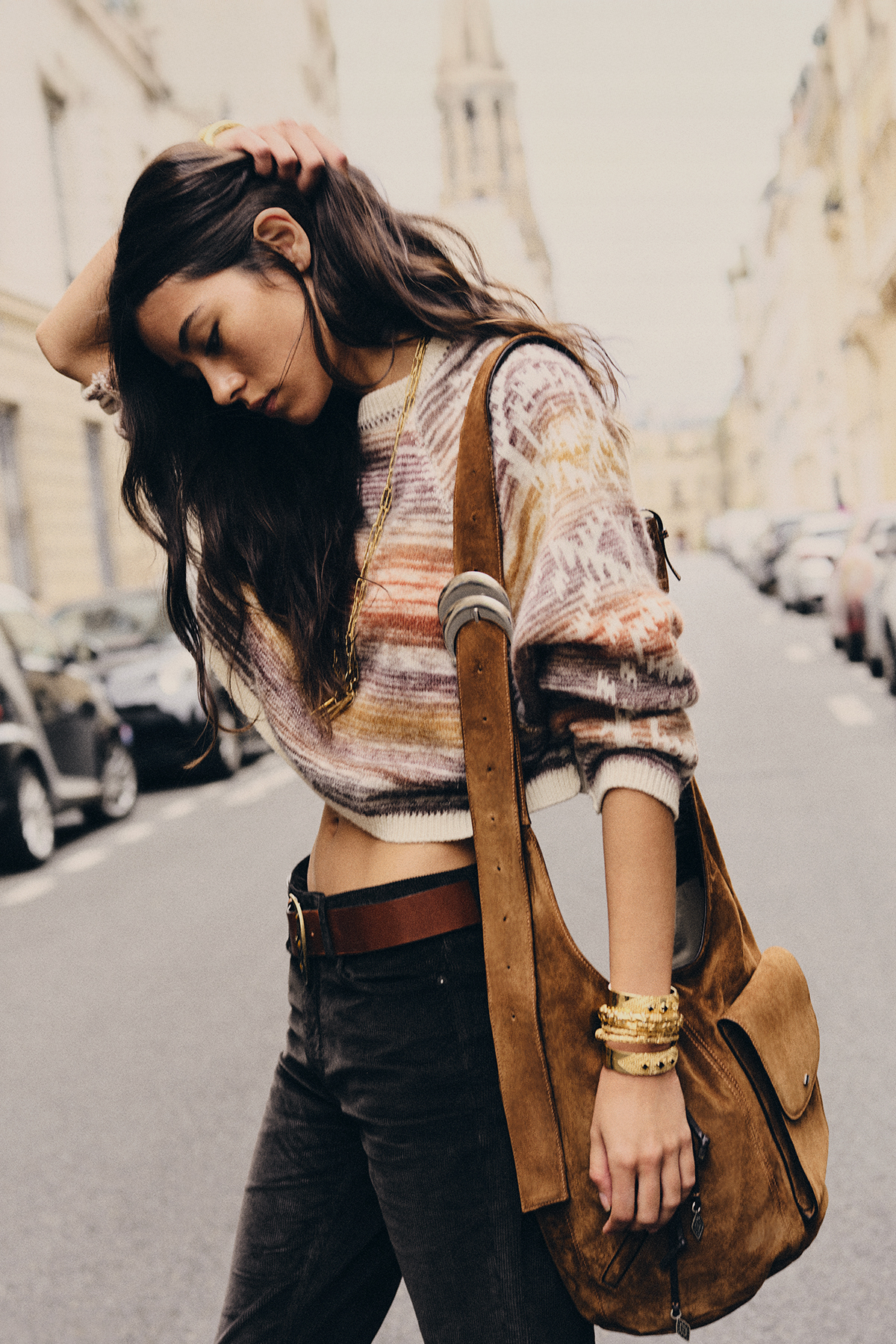 Woman wearing a printed knitted cardigan and the new iconic YOUYOU bag