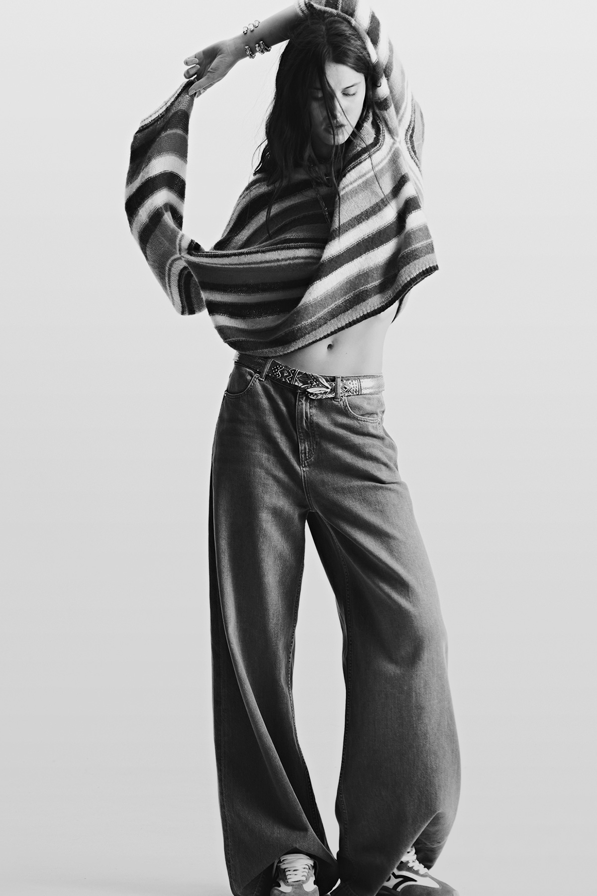 A model wearing a striped jumper and ba&sh jeans