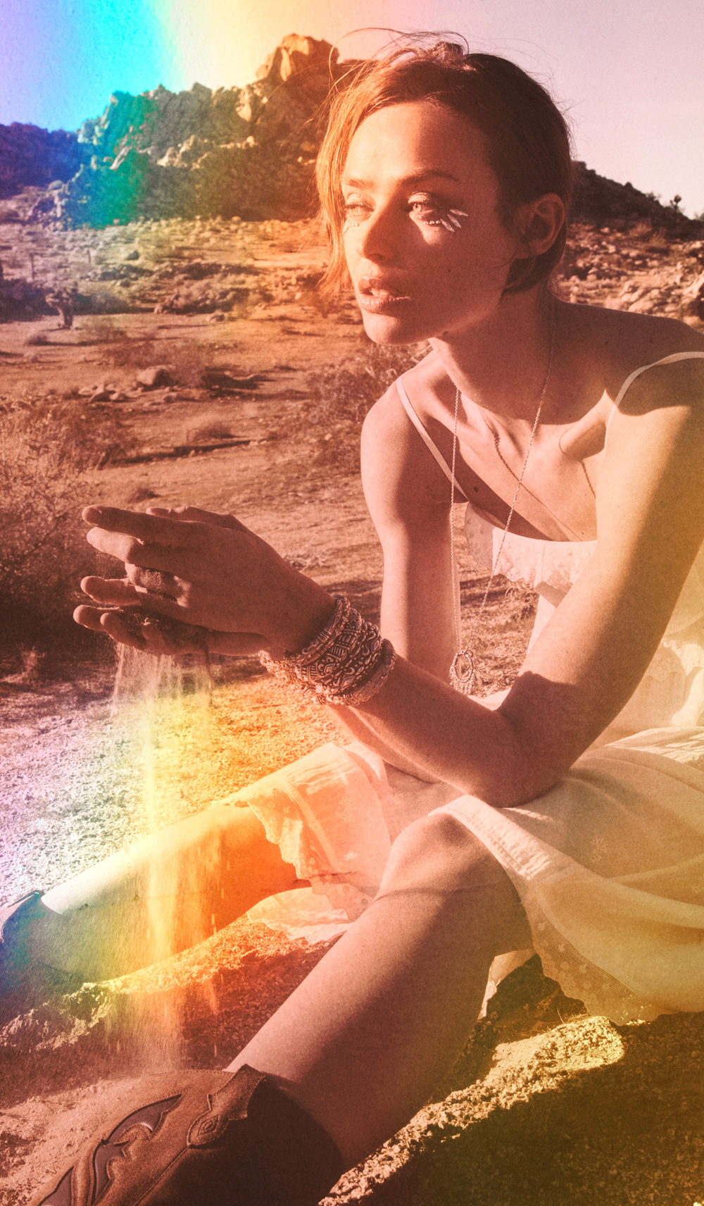 a woman in a yellow dress and brown cowboy boots in the desert