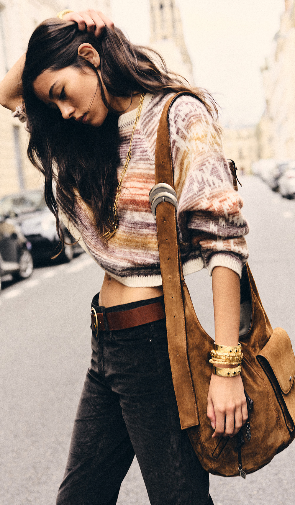 Long brown hair woman wearing printed cardigan and the new iconic youyou bag