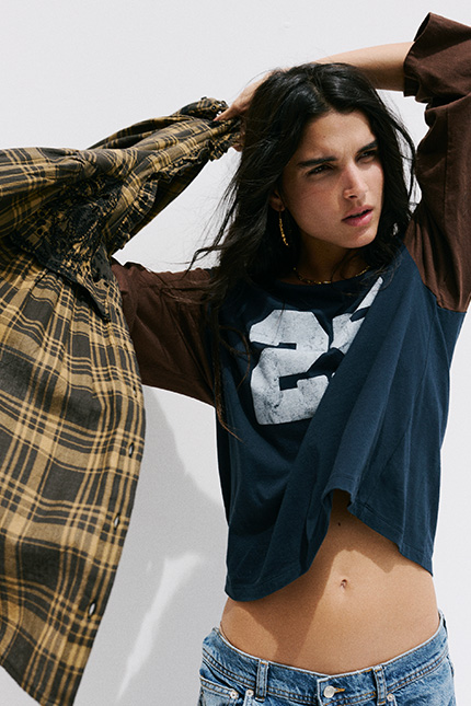 The model is wearing a top and a shirt