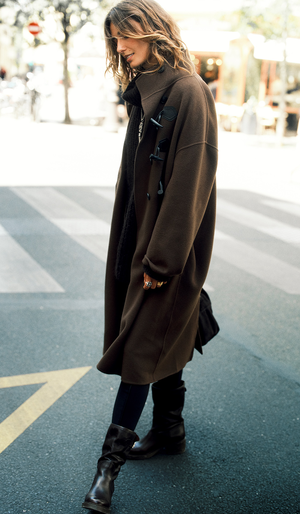 The model is wearing a long coat