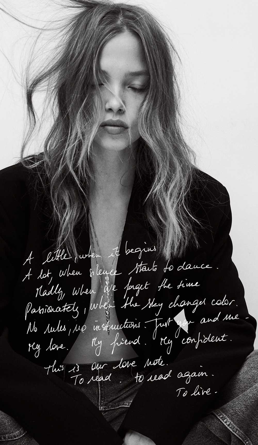 Woman wearing a black blazer and layered jewellery