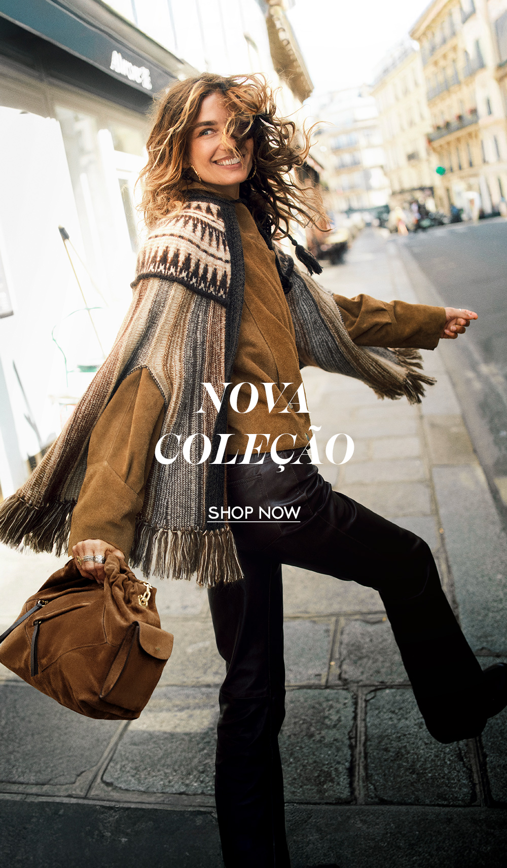 A model wearing a poncho and a bag