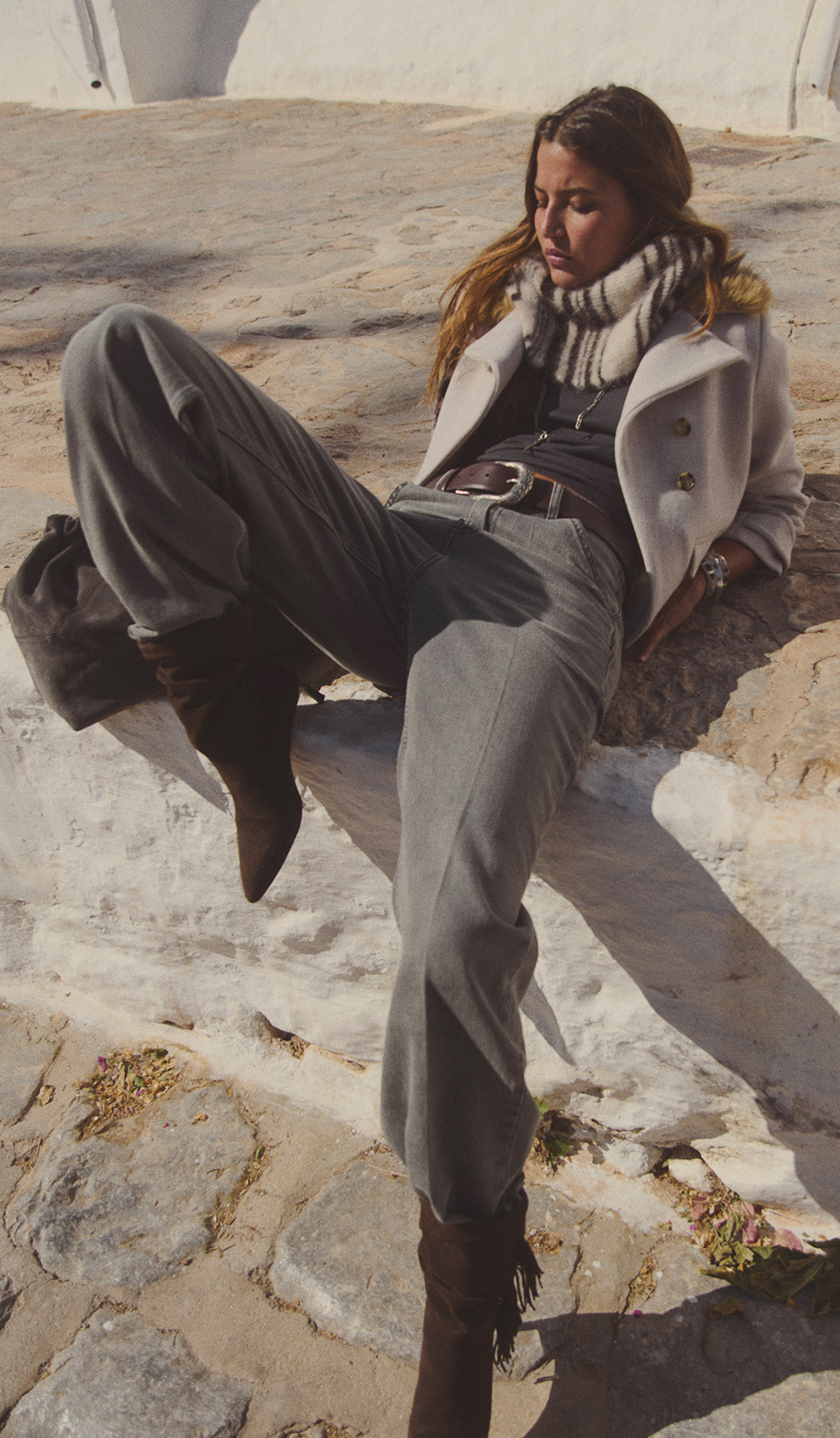 A model wearing a hat and a grey scarf