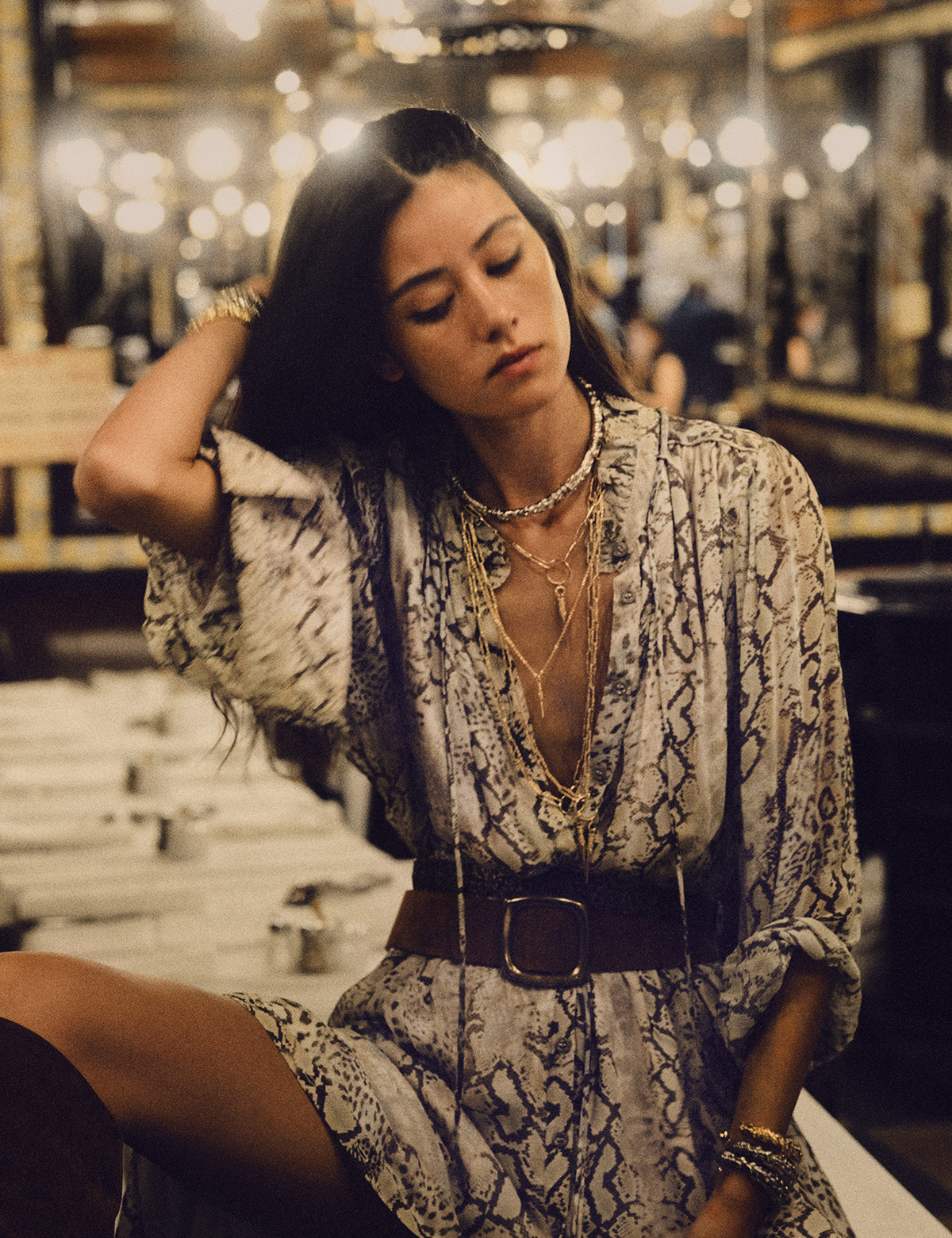 Happy days - woman wearing a snake print white dress with a leather belt