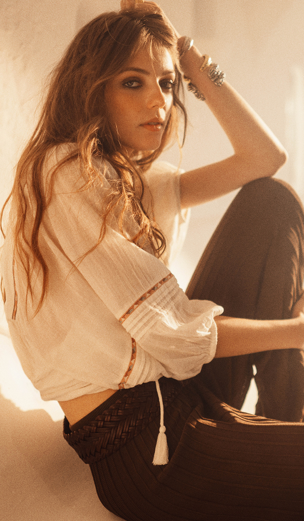 a model wearing a shirt and pants on the street 