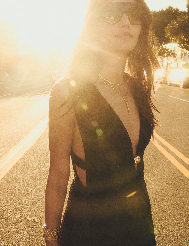 A model wearing a brown dress in the street