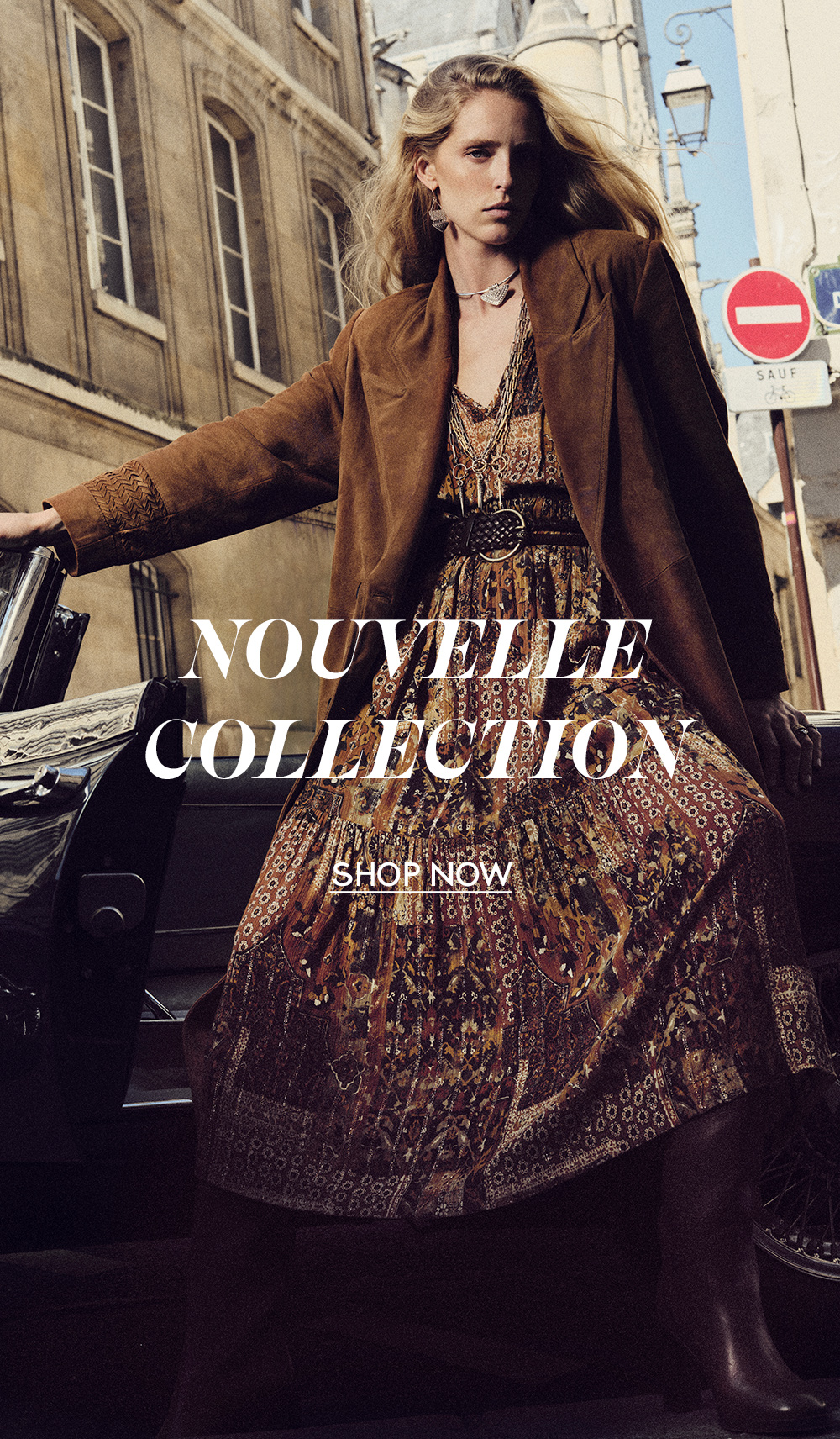 Abby Champion wearing a printed skirt and a brown blazer